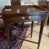 A GOOD QUALITY PAIR OF 20TH CENTURY MAHOGANY SIDE TABLES, each with a three quarter raised gallery, over a single drawer having a decorative brass handle, raised on tapered legs united with a x stretcher,