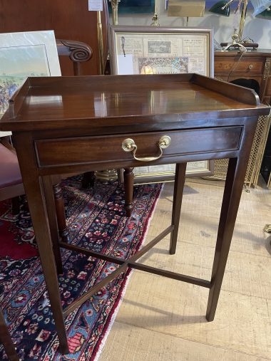A GOOD QUALITY PAIR OF 20TH CENTURY MAHOGANY SIDE TABLES, each with a three quarter raised gallery, over a single drawer having a decorative brass handle, raised on tapered legs united with a x stretcher,